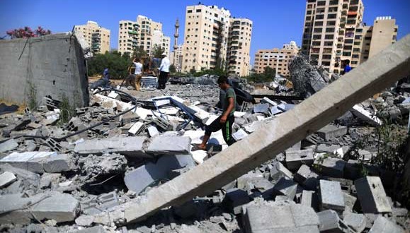 Palestinian boy inspecting damage following overnight Israeli airstrike in Gaza City.