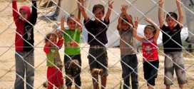 Syrian refugee children flash V-signs at